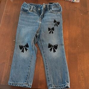 Blue jeans with four black bows decorations